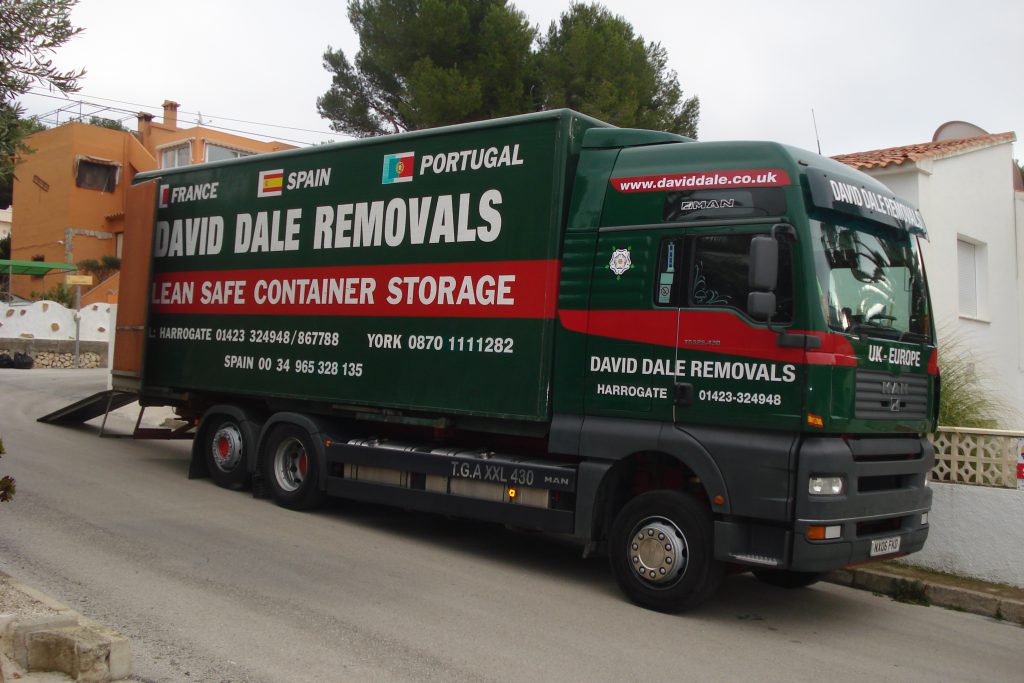 David Dale Removals truck with loading ramp deployed outside a Spanish apartment block, Barcelona to UK removals