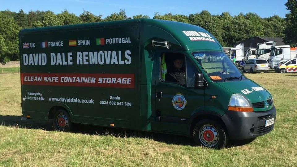 David Dale removals van loaded for an international move, Forest Moor Road depot in Knaresborough, rear doors open showing wrapped furniture