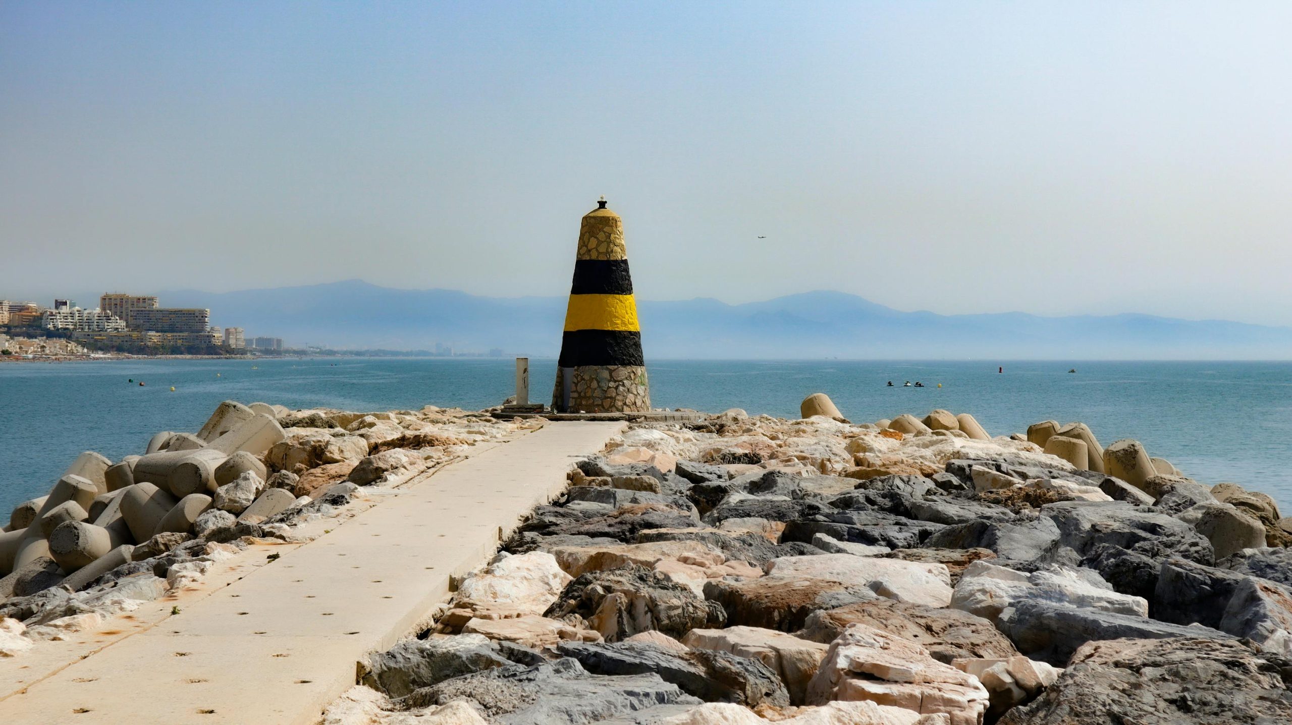 The seafront breakwater at Benalmadena marina, a coastal collection point for David Dale Removals' weekly Benalmadena to UK removal service