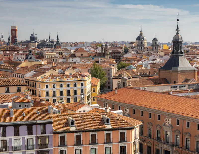 Aerial view of central Madrid showing terracotta rooftops and historic church spires, the city David Dale Removals collects from on the Madrid to UK route