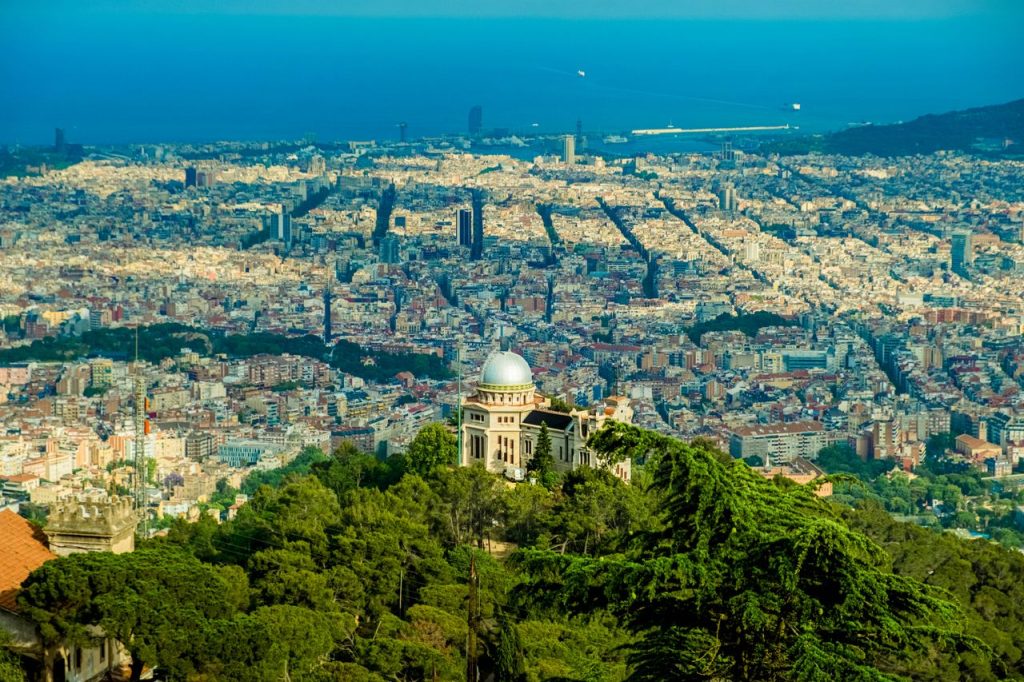 Aerial view of Barcelona city showing the Eixample grid and coastline, Spain