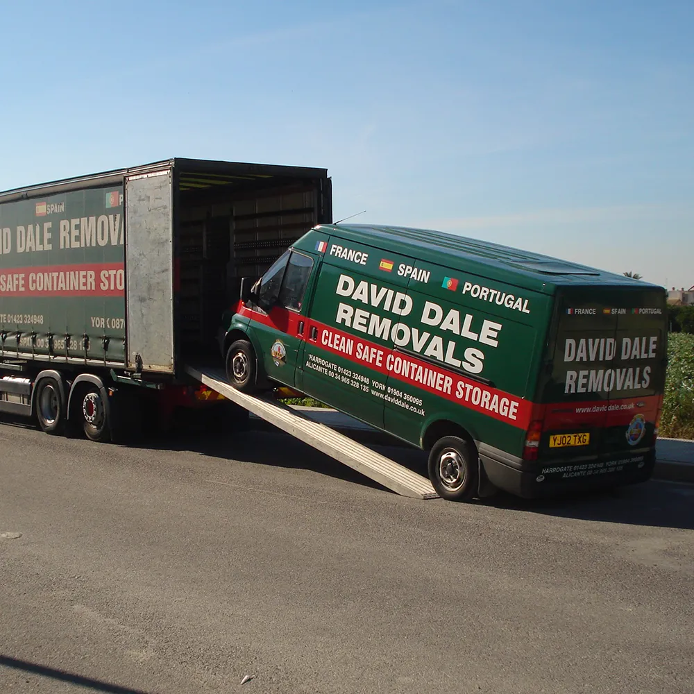 David Dale Removals lorry and van parked at a roadside stop in Spain, with loading ramp extended during a UK to Spain removal