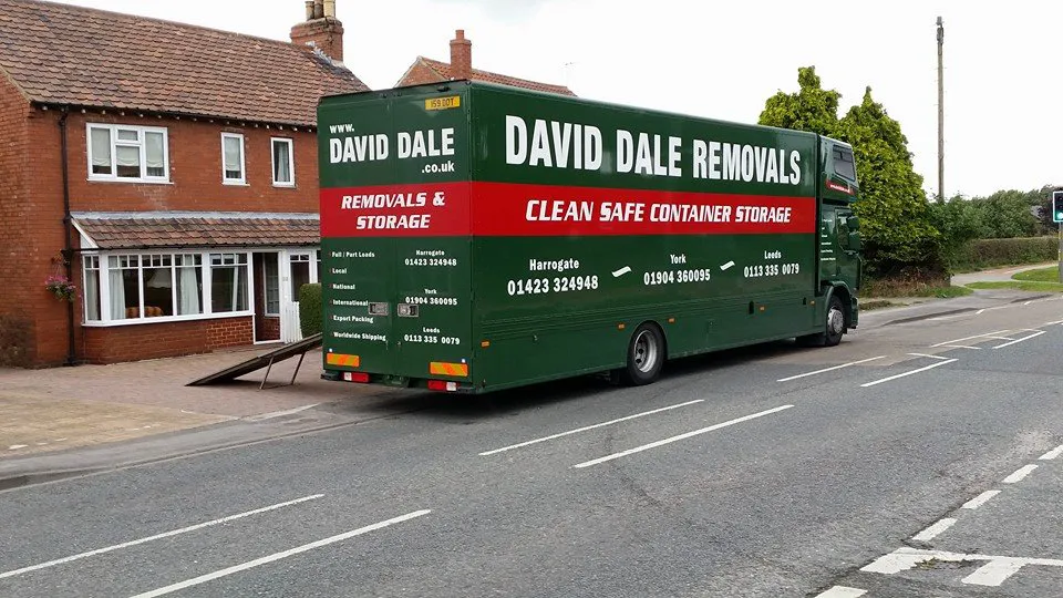 Green David Dale Removals lorry parked outside a North Yorkshire home, signwritten for removals and container storage